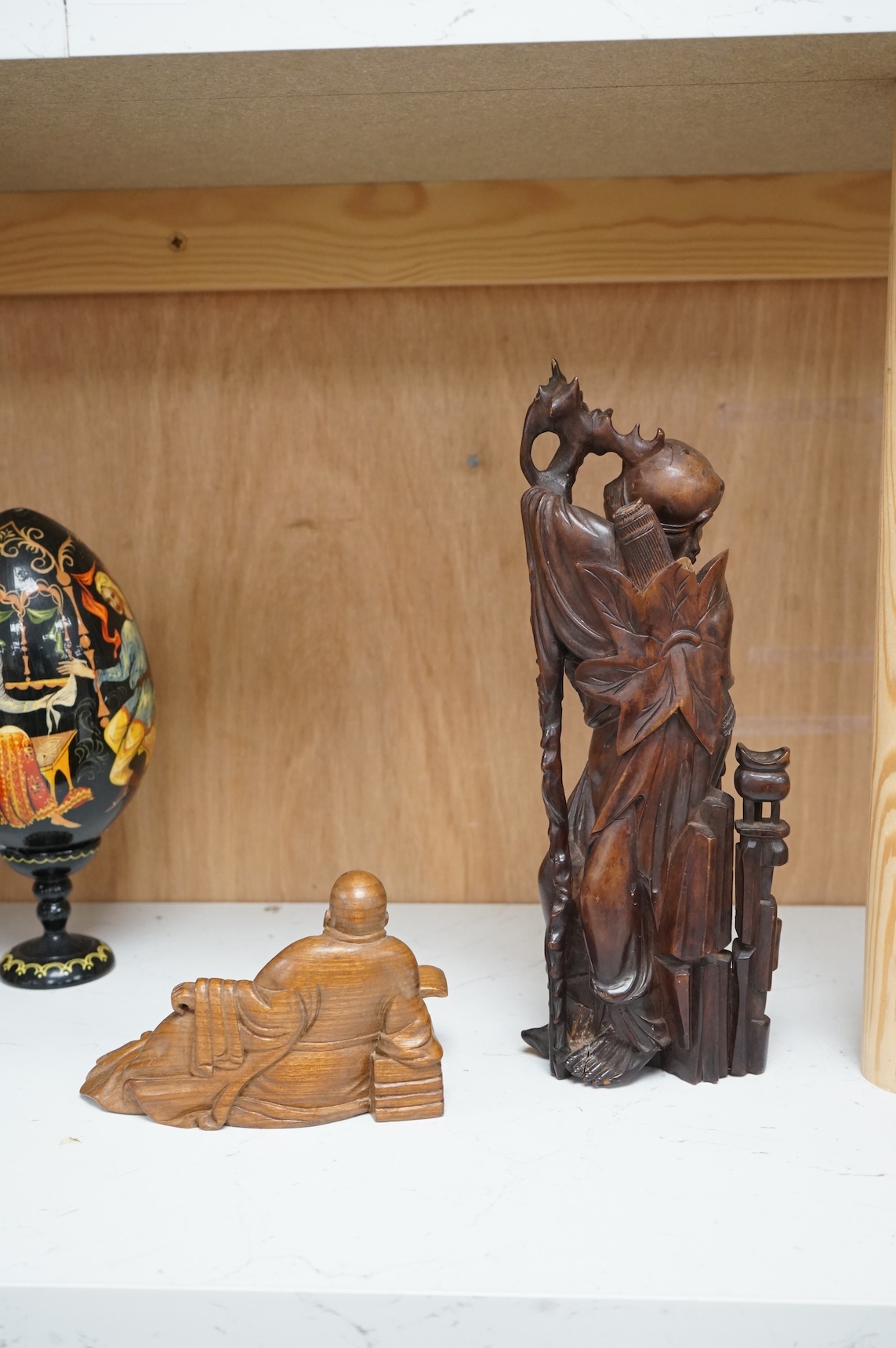 A Chinese root carving of a luohan and another of a reclining monk, largest 26cm high (2)